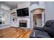 Living room featuring a brick fireplace, built-in shelves, and plenty of natural light at 8040 Banks Mill Rd, Douglasville, GA 30135