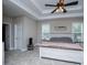 Spacious main bedroom featuring a tray ceiling, ceiling fan, and two windows providing natural light at 8040 Banks Mill Rd, Douglasville, GA 30135