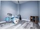 The room features a drum set, grey walls, hardwood floors, and a ceiling fan at 8040 Banks Mill Rd, Douglasville, GA 30135