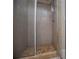 Tiled walk-in shower with stone floor and glass door, offering modern convenience at 8040 Banks Mill Rd, Douglasville, GA 30135