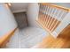 Carpeted stairs with a wooden handrail and white spindles leading to the lower level of the home at 8040 Banks Mill Rd, Douglasville, GA 30135
