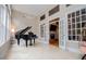 Bright sunroom with lots of windows, grand piano, and fireplace at 8040 Banks Mill Rd, Douglasville, GA 30135