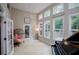 Bright sunroom with lots of windows, piano and egg chair at 8040 Banks Mill Rd, Douglasville, GA 30135