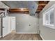 Unfinished basement features new vinyl flooring, paint, and utility hookups at 847 Magna Carta Nw Dr, Atlanta, GA 30318