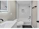 Modern bathroom featuring a tiled tub, modern fixtures, and ample lighting at 847 Magna Carta Nw Dr, Atlanta, GA 30318