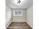 Cozy bedroom with wood floors, a modern light fixture, and neutral paint, creating a serene space at 847 Magna Carta Nw Dr, Atlanta, GA 30318