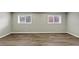 Bedroom featuring two windows with mini blinds and vinyl plank flooring at 847 Magna Carta Nw Dr, Atlanta, GA 30318
