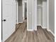 Hallway with wood-look floors, fresh paint and ample closet space at 847 Magna Carta Nw Dr, Atlanta, GA 30318