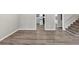 Empty living room with plank flooring featuring neutral paint, and staircase access at 847 Magna Carta Nw Dr, Atlanta, GA 30318