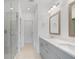Stylish bathroom with double vanity, white countertops, framed mirrors, and glass shower at 102 Brackley Dr, Cumming, GA 30040