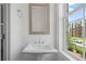 Bright bathroom with a pedestal sink and a window offering an outdoor view at 102 Brackley Dr, Cumming, GA 30040