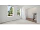 A carpeted bedroom featuring all-white walls, two windows and an adjoining room at 102 Brackley Dr, Cumming, GA 30040