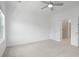 Bright bedroom features neutral carpet, ceiling fan, and ensuite bath with frameless shower at 102 Brackley Dr, Cumming, GA 30040