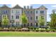Attractive townhome exterior with white-painted brick, black fence and well-manicured landscaping at 102 Brackley Dr, Cumming, GA 30040