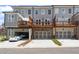 Townhome exterior with garage and wooden balcony at 102 Brackley Dr, Cumming, GA 30040