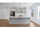 Bright, modern kitchen featuring stainless steel appliances, gray cabinets, and a central island at 102 Brackley Dr, Cumming, GA 30040