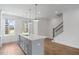 Spacious kitchen featuring a large island with seating and modern fixtures at 102 Brackley Dr, Cumming, GA 30040