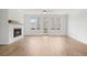 Bright living room with fireplace, ceiling fan and large windows at 102 Brackley Dr, Cumming, GA 30040