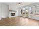 Open living room featuring a fireplace, large windows, and access to outdoor balcony at 102 Brackley Dr, Cumming, GA 30040