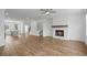 Open living room area with a fireplace, ceiling fan, and stylish flooring at 102 Brackley Dr, Cumming, GA 30040