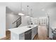 Open-concept living space with kitchen island, staircase, and inviting living area at 102 Brackley Dr, Cumming, GA 30040
