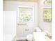 This bathroom includes a bath tub, toilet, vanity, mirror and a window for natural light at 1947 Main St, Atlanta, GA 30318