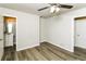 A bright bedroom with wood floors, grey walls, and access to the bathroom through an open door at 1947 Main St, Atlanta, GA 30318