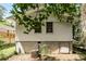 Back view of home featuring white siding, basement, and a fenced in yard at 1947 Main St, Atlanta, GA 30318