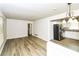 Open-concept living area with hardwood floors, neutral walls, leading into the kitchen with stainless steel appliances at 1947 Main St, Atlanta, GA 30318