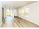 Inviting living space featuring hardwood floors, light gray walls, and large windows offering ample sunlight at 1947 Main St, Atlanta, GA 30318