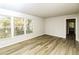 Spacious living area boasting hardwood floors, neutral walls, and large windows for plenty of natural light at 1947 Main St, Atlanta, GA 30318