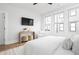Cozy bedroom showcasing large windows, a flat-screen TV, and hardwood floors, creating a relaxing atmosphere at 332 Gibson Se St, Atlanta, GA 30316