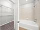 Well-lit bathroom with a walk-in closet featuring a bathtub and shower combo at 5300 Peachtree Rd # 2309, Chamblee, GA 30341