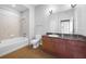 Bathroom with a bathtub and shower, along with a granite countertop vanity and mirror at 5300 Peachtree Rd # 2309, Chamblee, GA 30341