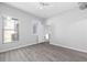Bright bedroom with grey wood-look flooring, ceiling fan, and light grey walls at 5300 Peachtree Rd # 2309, Chamblee, GA 30341