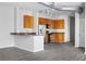 Modern kitchen with a breakfast bar, stainless steel appliances, granite countertops, and wood cabinets at 5300 Peachtree Rd # 2309, Chamblee, GA 30341