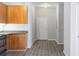 Open-concept kitchen with wood cabinets, granite countertops, and modern appliances at 5300 Peachtree Rd # 2309, Chamblee, GA 30341
