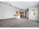 Open-concept layout featuring wood-look floors, kitchen with granite countertops, and exposed ductwork at 5300 Peachtree Rd # 2309, Chamblee, GA 30341