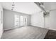 Bright living room featuring modern track lighting, wood-look floors, and access to a balcony with natural light at 5300 Peachtree Rd # 2309, Chamblee, GA 30341