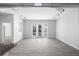 Contemporary living room with wood-look flooring, track lighting, and large windows for ample natural light at 5300 Peachtree Rd # 2309, Chamblee, GA 30341