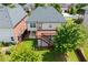 Aerial view of a two-story home with a wooden deck, yard, and mature trees at 812 Autry Oak Ct, Alpharetta, GA 30022