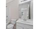 Bright bathroom with white vanity, toilet, tub, and a large mirror at 812 Autry Oak Ct, Alpharetta, GA 30022