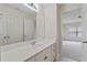 Bathroom vanity and sink with a large mirror overlooking a door leading to bonus room at 812 Autry Oak Ct, Alpharetta, GA 30022