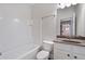 Bright bathroom featuring white tile, vanity, and tub at 812 Autry Oak Ct, Alpharetta, GA 30022