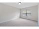 Bright bedroom features neutral paint, carpet, and natural light from a window at 812 Autry Oak Ct, Alpharetta, GA 30022