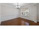 Formal dining room with hardwood floors, decorative molding, chandelier, and a window with natural light at 812 Autry Oak Ct, Alpharetta, GA 30022
