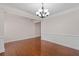 Formal dining room with hardwood floors, decorative molding, chandelier, and adjoining area at 812 Autry Oak Ct, Alpharetta, GA 30022