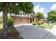 Two-story brick home with a two-car garage and long driveway at 812 Autry Oak Ct, Alpharetta, GA 30022