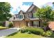 Charming two-story brick home featuring a two-car garage, landscaped yard, and covered front porch at 812 Autry Oak Ct, Alpharetta, GA 30022