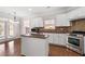 Updated kitchen with stainless steel appliances, granite countertops, and center island at 812 Autry Oak Ct, Alpharetta, GA 30022
